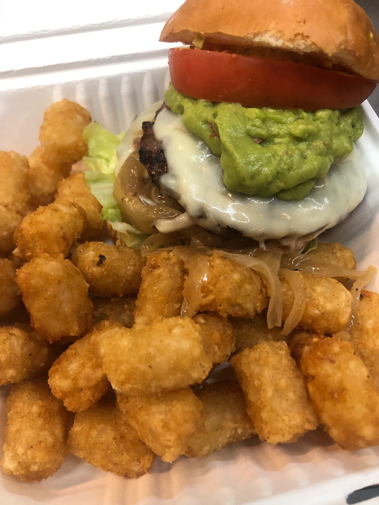 Double Swiss cheese burger with guacamole and tater tots